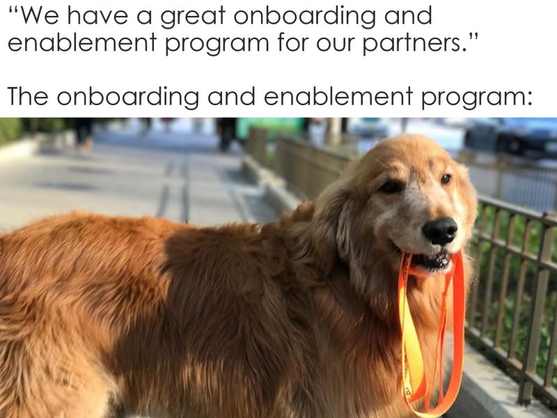 Meme: we have a great onboarding and enablement program for our partners. Image: of dog holding leash with teeth.